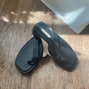 Saks black leather flip flops